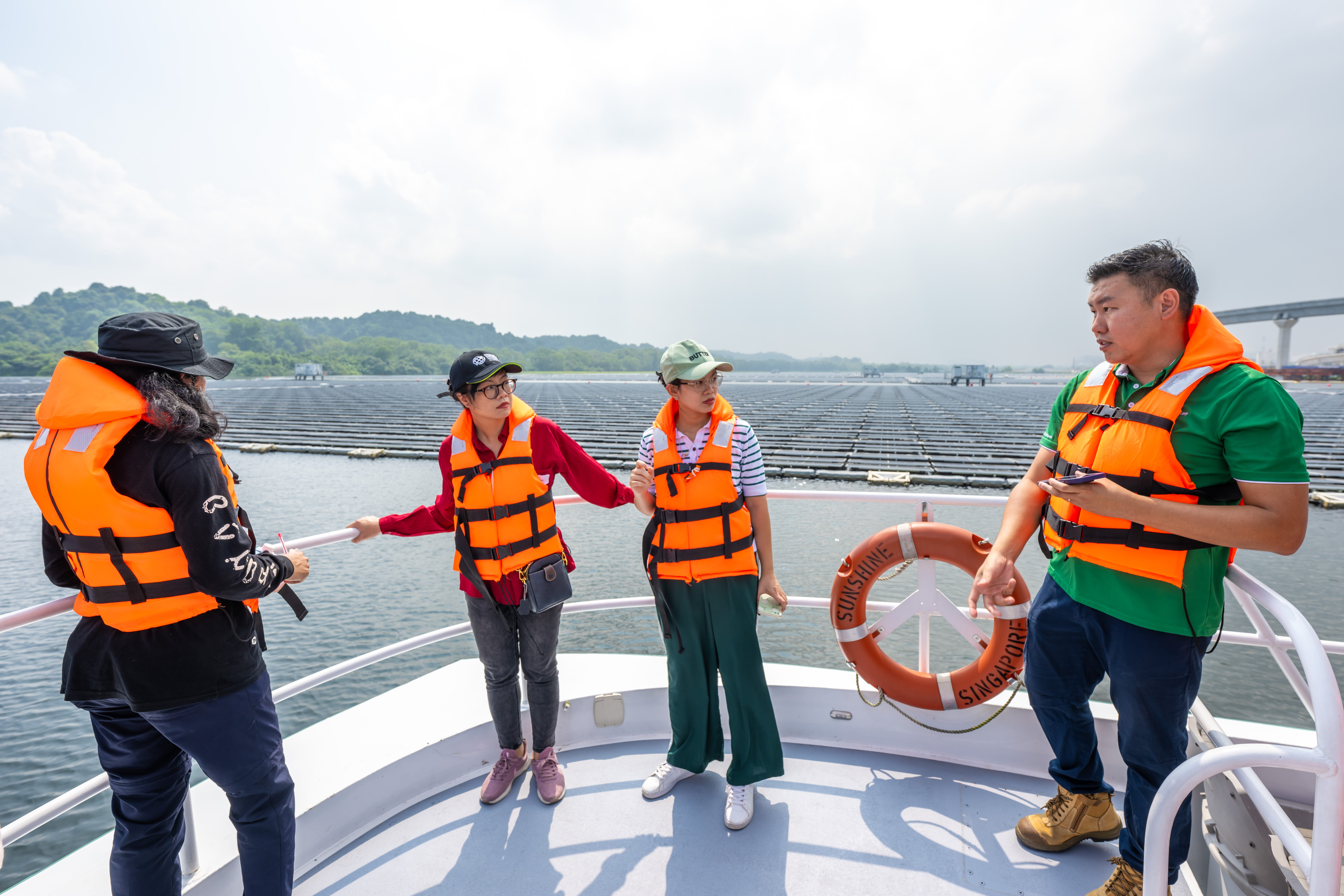 Journalists on a boat tour of the Sembcorp Tengeh Floating Solar Farm